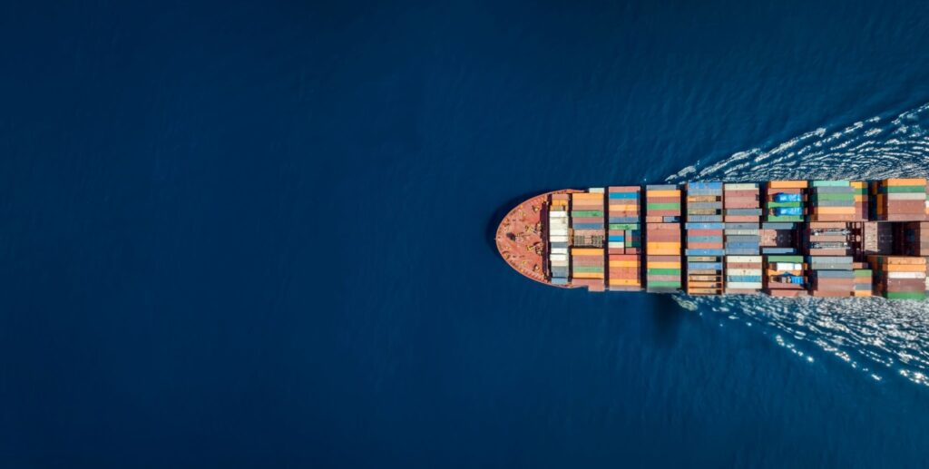 Cargo ship transporting second hand clothing containers across international waters