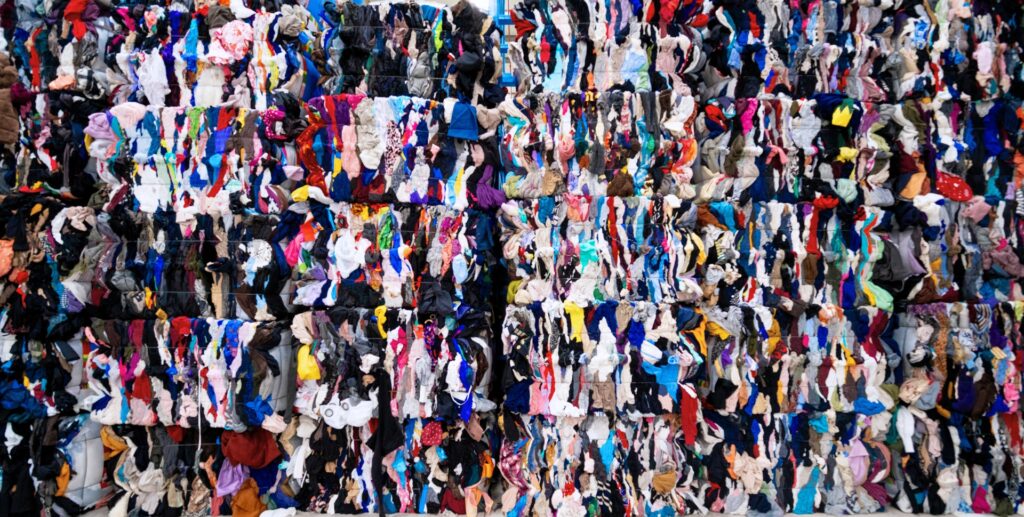 Bundled recycled clothes for rags and wipers stored in warehouse racks